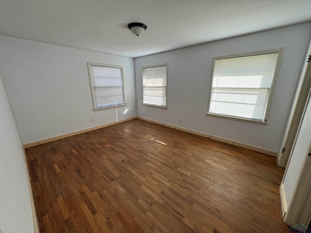 spare room featuring dark hardwood / wood-style floors