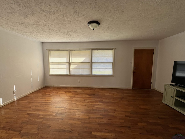 unfurnished living room featuring a textured ceiling and dark hardwood / wood-style flooring