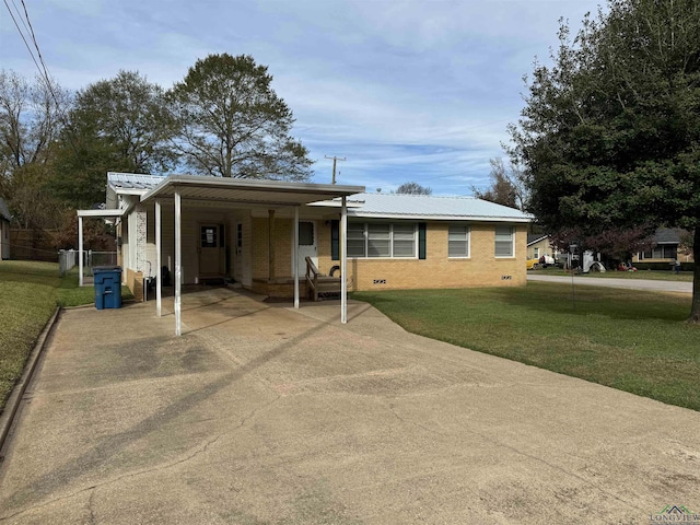 view of front facade with a carport and a front lawn