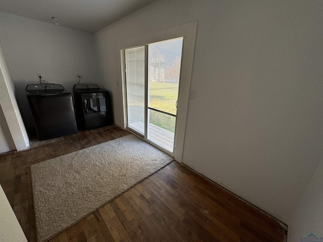 clothes washing area with dark hardwood / wood-style flooring and independent washer and dryer