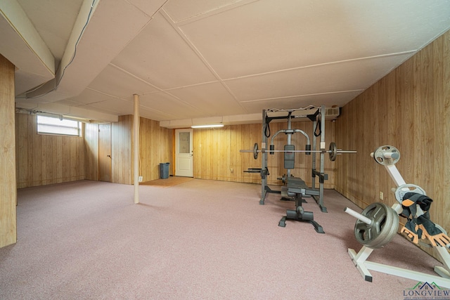 workout area with carpet floors and wooden walls