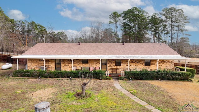 single story home with a porch and a front yard