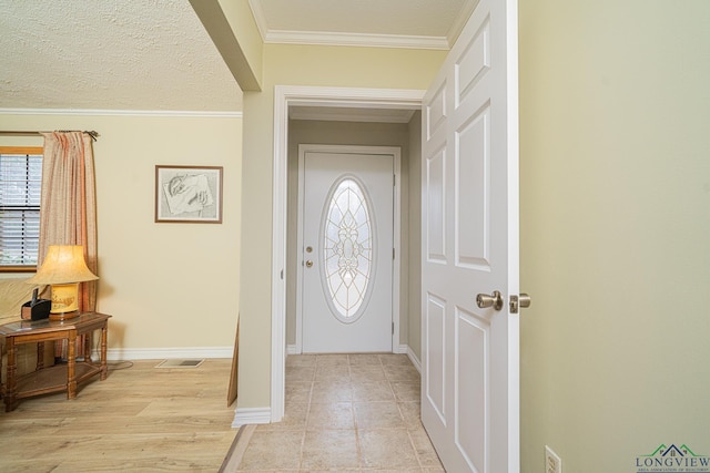 entrance foyer featuring crown molding and light wood-type flooring