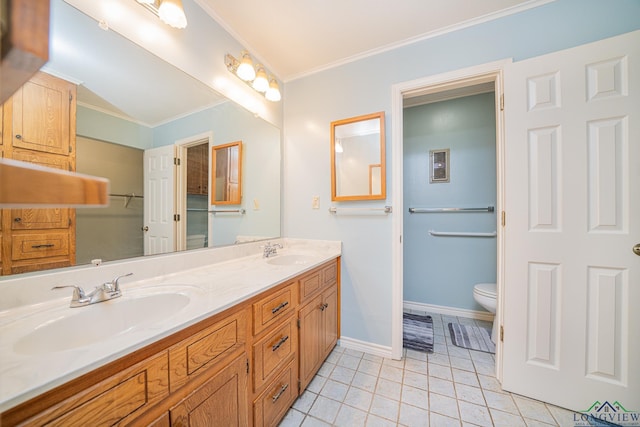 bathroom featuring tile patterned floors, ornamental molding, toilet, and vanity