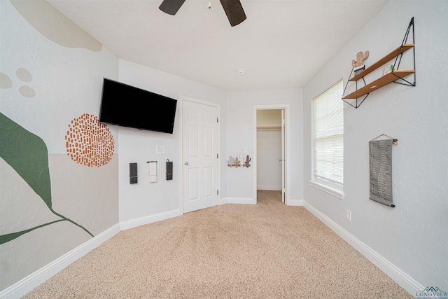 1700 Van Zandt Ave, Marshall, TX 75670 - unfurnished bedroom featuring carpet flooring, a ceiling fan, and a spacious closet