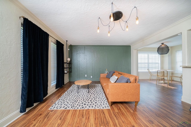 1700 Van Zandt Ave, Marshall, TX 75670 - living room featuring wood finished floors, a textured ceiling, and ornamental molding