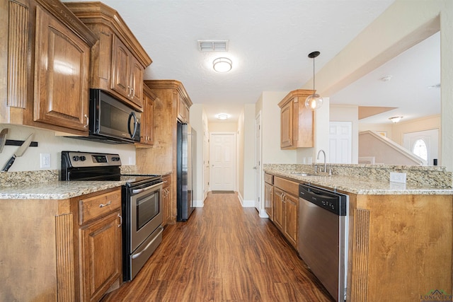 1700 Van Zandt Ave, Marshall, TX 75670 - kitchen with stainless steel appliances, dark wood-type flooring, light stone countertops, and a peninsula