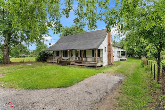 154 County Rd 117, Carthage, TX 75633 - view of front of property featuring covered porch and a shingled roof