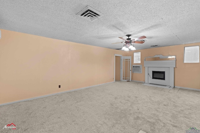 154 County Rd 117, Carthage, TX 75633 - unfurnished living room with ceiling fan, carpet floors, a fireplace with flush hearth, a textured ceiling, and an AC wall unit