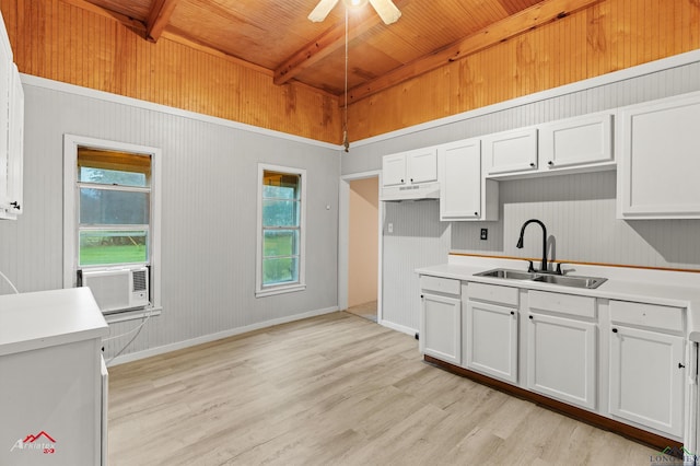 154 County Rd 117, Carthage, TX 75633 - kitchen featuring a wooden ceiling with exposed beams, light wood-style flooring, cooling unit, healthy amount of natural light, and wood walls