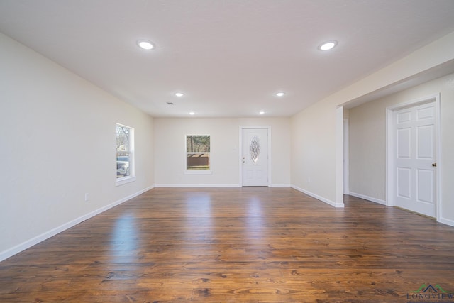 unfurnished room featuring recessed lighting, baseboards, and dark wood-style flooring