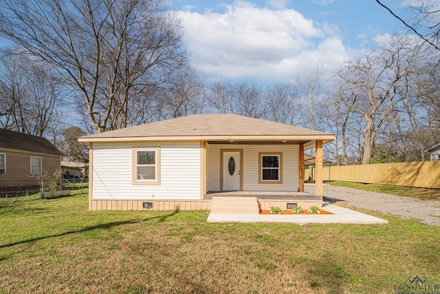 view of front of house with fence, driveway, covered porch, a front lawn, and crawl space