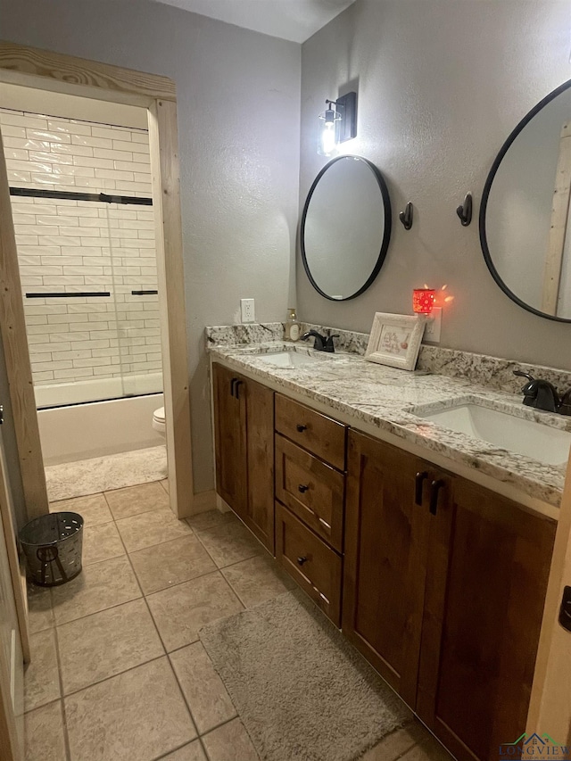 full bathroom featuring tile patterned floors, vanity, toilet, and tiled shower / bath