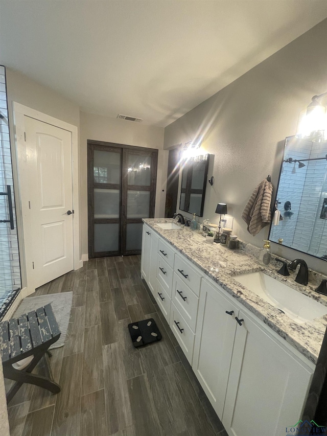 bathroom featuring vanity and a shower