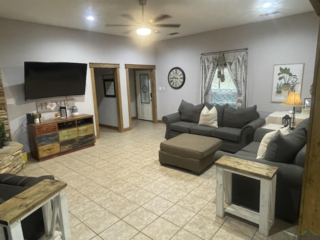 living room featuring light tile patterned floors and ceiling fan