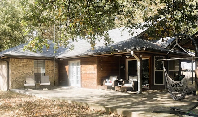 back of property with french doors and a patio