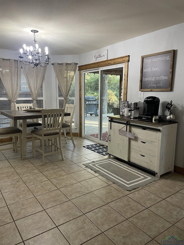 tiled dining room with a textured ceiling and a chandelier