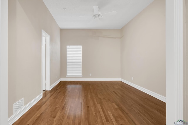 empty room with hardwood / wood-style floors and ceiling fan