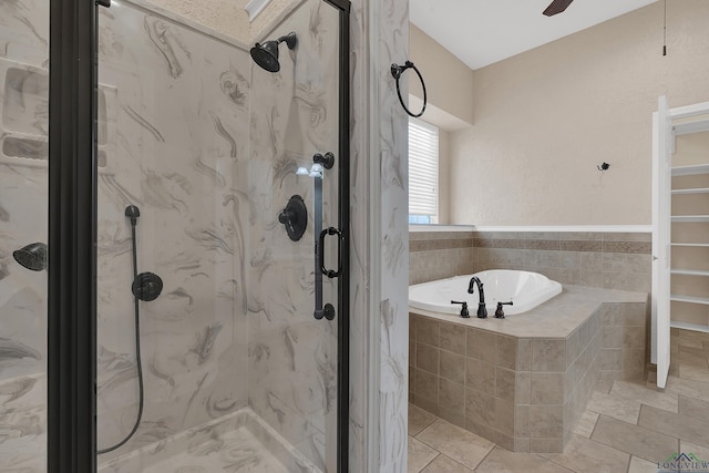 bathroom featuring ceiling fan and plus walk in shower