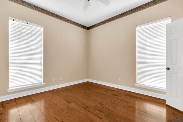 unfurnished room featuring hardwood / wood-style floors and ceiling fan