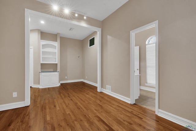 unfurnished room featuring wood-type flooring