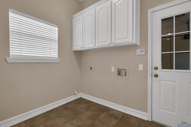 laundry area featuring electric dryer hookup, hookup for a washing machine, and cabinets