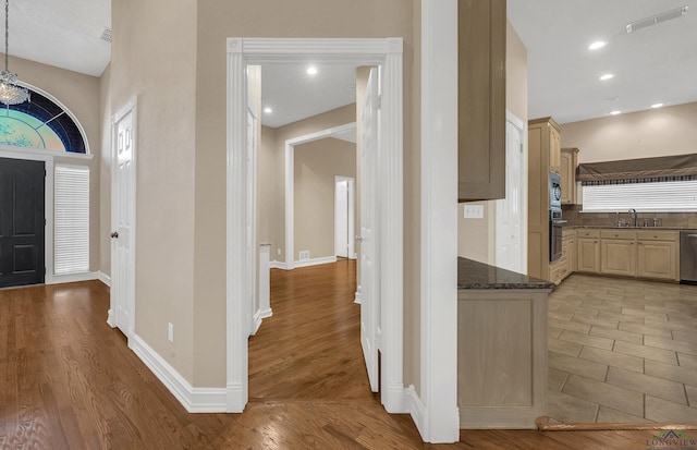 entryway with light hardwood / wood-style flooring and sink