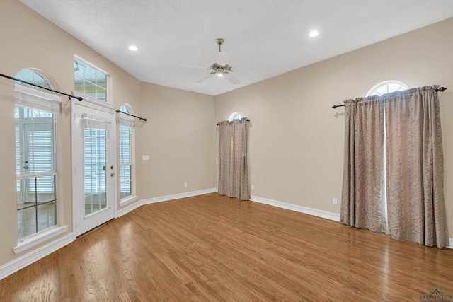 spare room with light hardwood / wood-style floors and ceiling fan