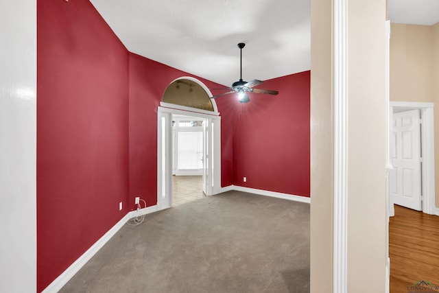 unfurnished room featuring carpet, ceiling fan, and lofted ceiling