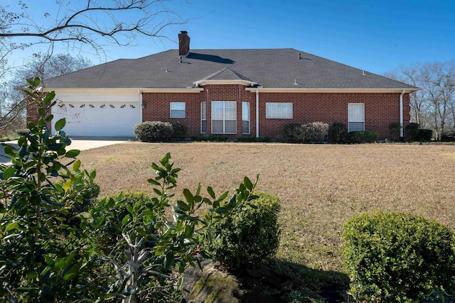 back of house featuring a yard and a garage