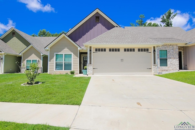 2131 Page Creek Trl, Longview, TX 75601 - view of front of house featuring board and batten siding, a garage, concrete driveway, stone siding, and a front yard