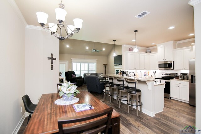 2131 Page Creek Trl, Longview, TX 75601 - dining space with a chandelier, dark wood-style flooring, a ceiling fan, recessed lighting, and ornamental molding