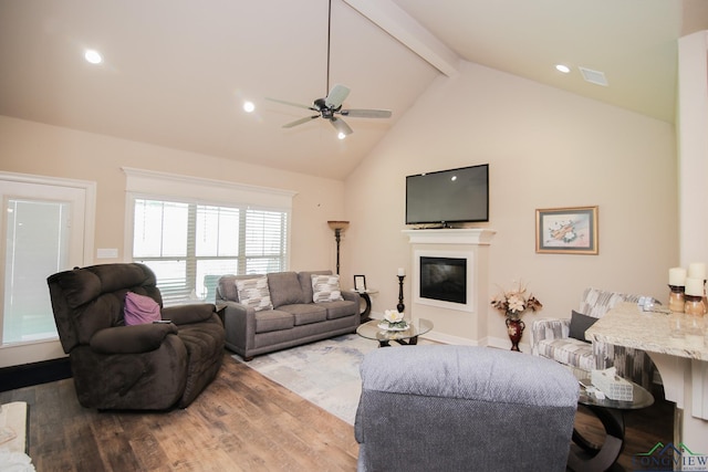 2131 Page Creek Trl, Longview, TX 75601 - living room with a ceiling fan, wood finished floors, beam ceiling, high vaulted ceiling, and a glass covered fireplace