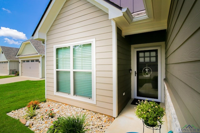 2131 Page Creek Trl, Longview, TX 75601 - view of exterior entry with a yard, an attached garage, and driveway