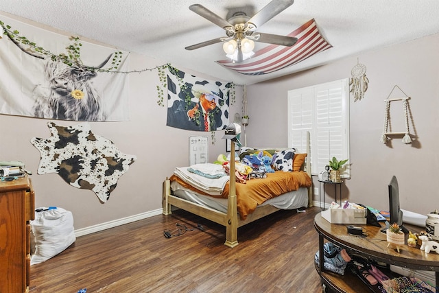 bedroom featuring ceiling fan, dark wood-type flooring, and a textured ceiling