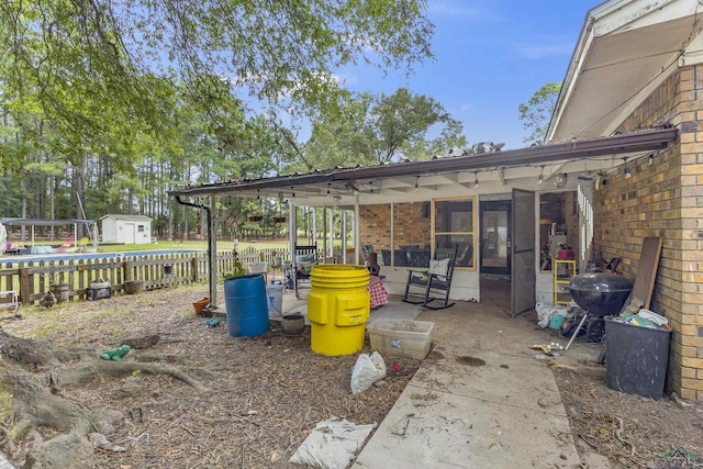view of patio featuring a shed and grilling area