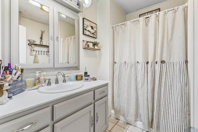 bathroom featuring tile patterned floors, vanity, and a textured ceiling