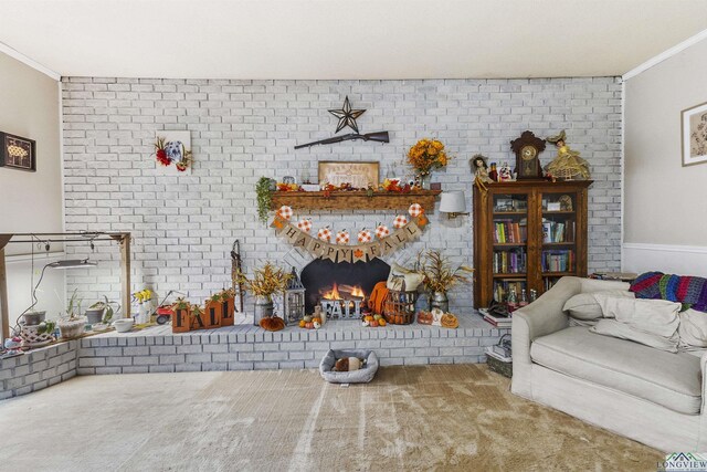 carpeted living room with crown molding and a brick fireplace