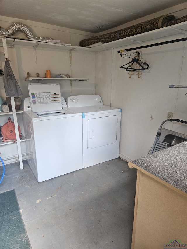 clothes washing area featuring washer and clothes dryer