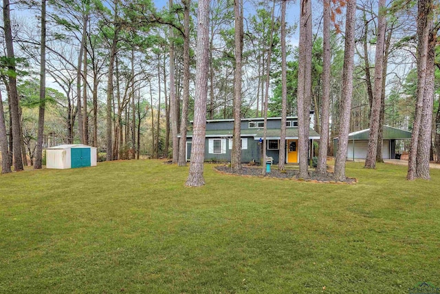 view of yard with a garage, a storage shed, and an outbuilding