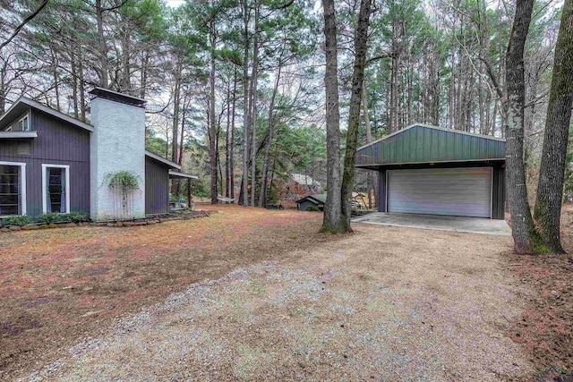 view of yard featuring a garage and an outdoor structure