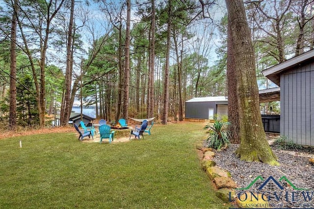 view of yard featuring an outdoor fire pit