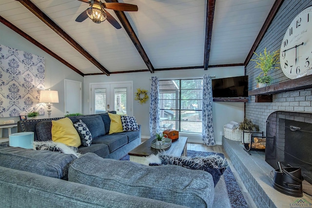 living room with lofted ceiling with beams, baseboards, wood finished floors, and french doors