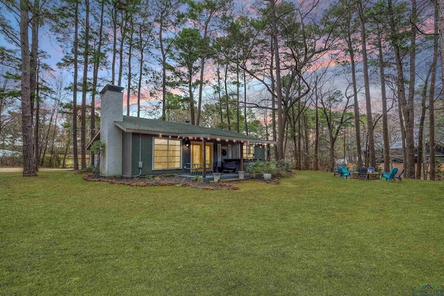 yard at dusk featuring a fire pit