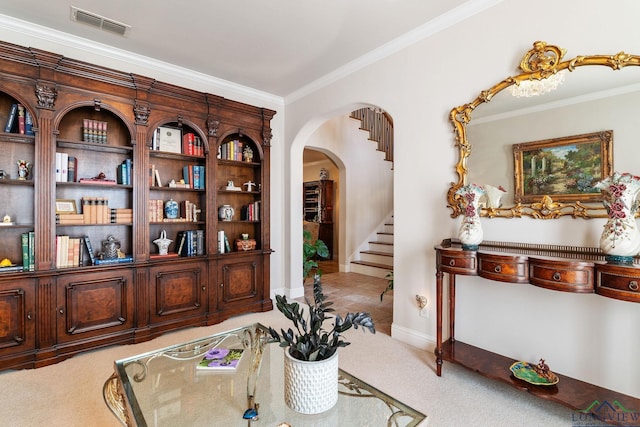 interior space with crown molding and light colored carpet