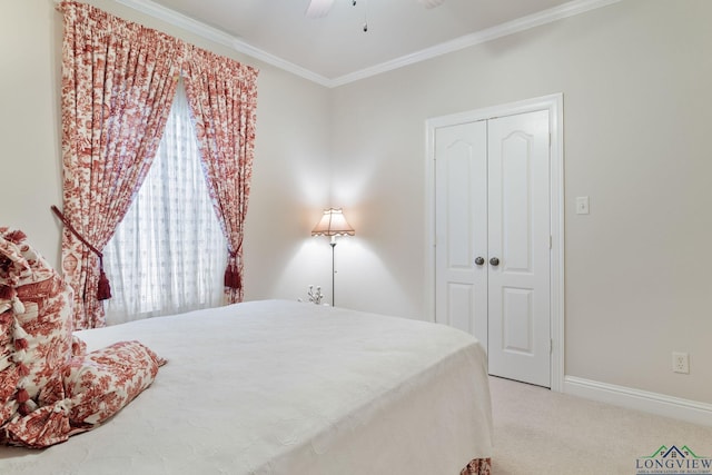 carpeted bedroom featuring crown molding, a closet, and ceiling fan