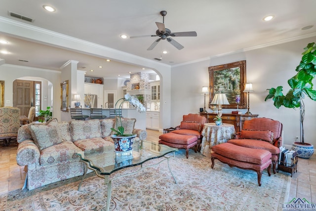 living room with crown molding and ceiling fan