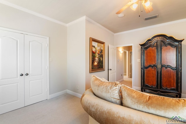 interior space with ornamental molding, light carpet, and ceiling fan