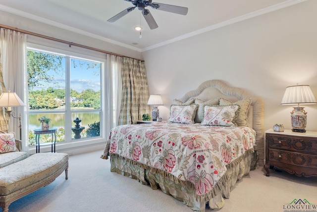 bedroom with crown molding, ceiling fan, and carpet floors