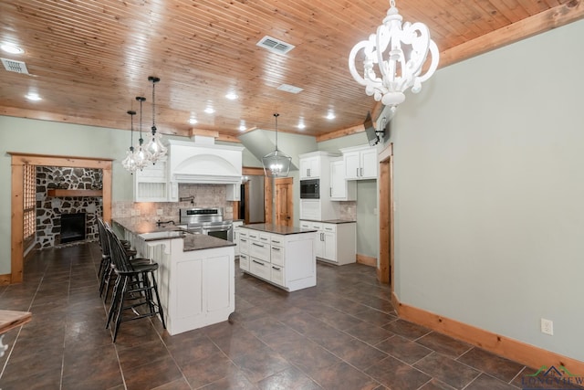 kitchen featuring an inviting chandelier, stainless steel range with electric stovetop, a fireplace, dark countertops, and wood ceiling
